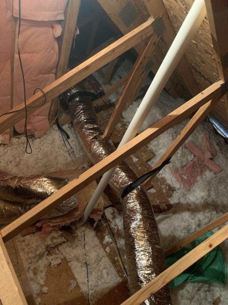 Flex ductwork and a condensate line among attic framing